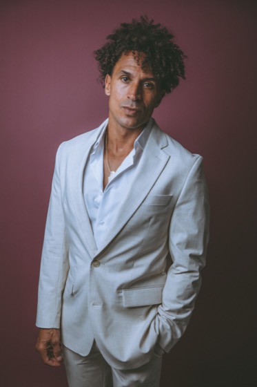 Personal brand portrait, tailored suit on a burgundy studio backdrop