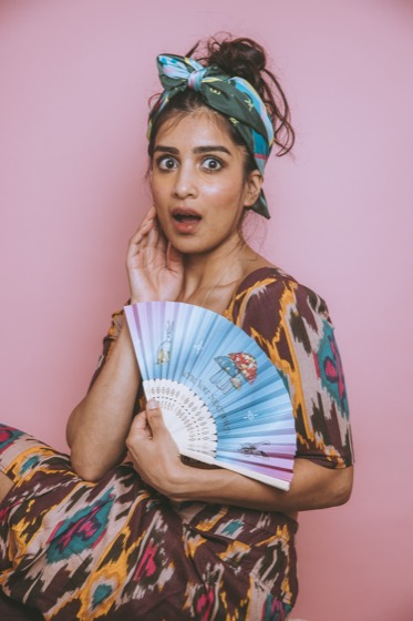 Expressive editorial personal brand portrait with a hand fan
