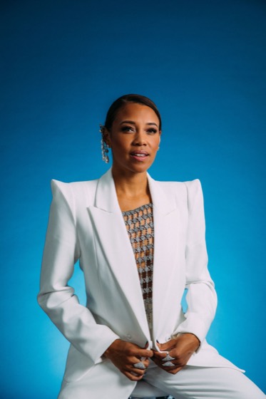 Powerful personal brand portrait, white blazer on a blue backdrop